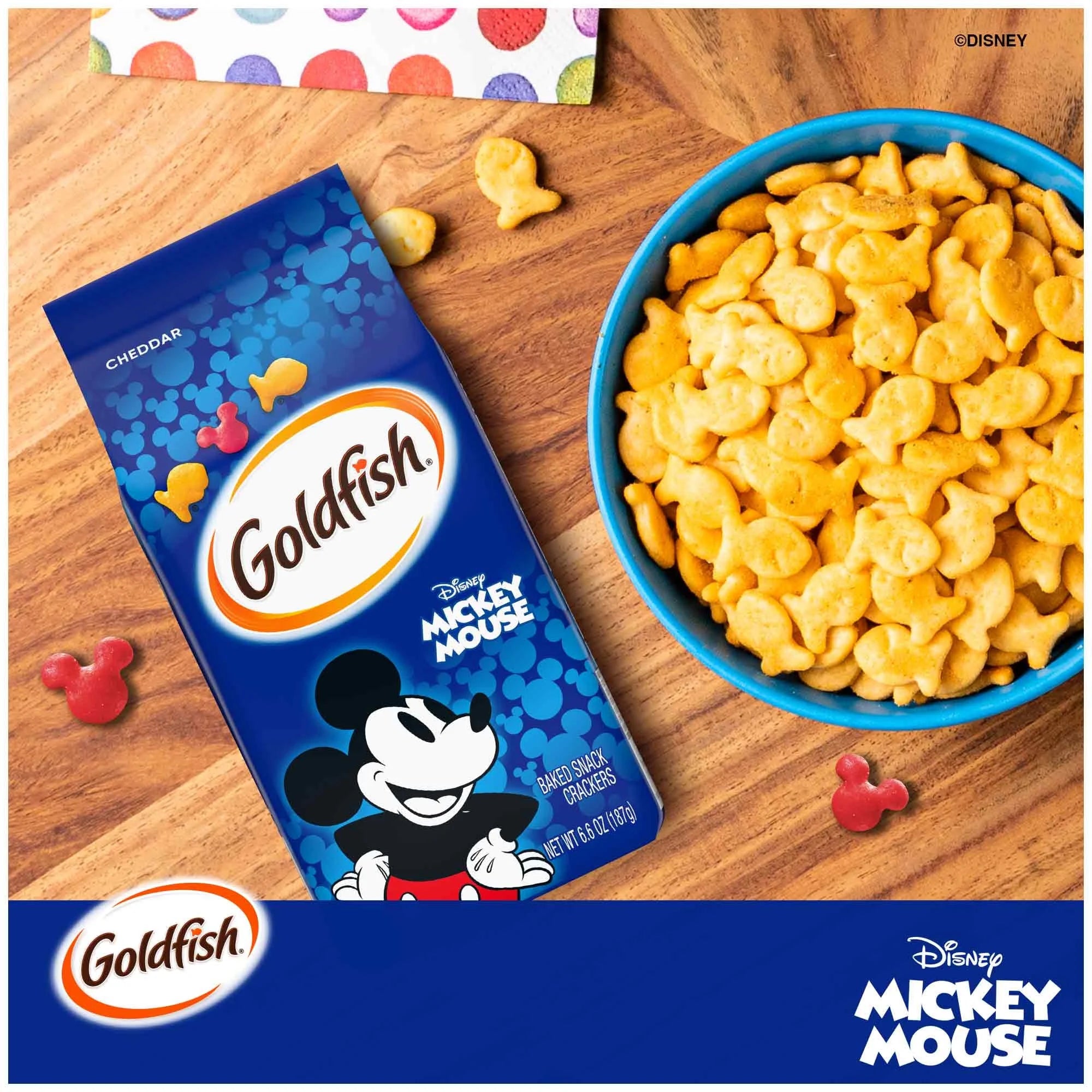 Goldfish Disney Mickey Mouse crackers in a bowl and packaging on a wooden surface